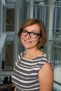 Mason associate professor Viviana Maggioni wears a striped blouse and glasses in her faculty profile