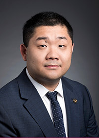 Wenying Ji wears a dark suit and tie in his faculty profile for the Civil Engineering department at George Mason University