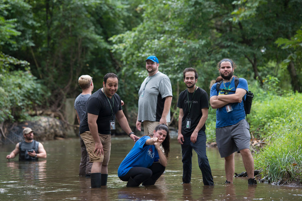 A group of civil engineering students monitoring flood levels in a river. 